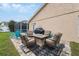 Relaxing backyard patio with fire pit, seating area, and grill at 11424 Zenith Cir, Tampa, FL 33635