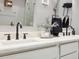 Double vanity with marble countertop, black matte fixtures at 11424 Zenith Cir, Tampa, FL 33635