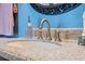 Bathroom featuring a granite countertop, updated sink, and elegant brushed gold faucet at 11424 Zenith Cir, Tampa, FL 33635