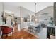 Bright dining room features a large table, chandelier, and hardwood floors at 11424 Zenith Cir, Tampa, FL 33635