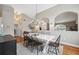 Open concept dining room with hardwood floors and chandelier at 11424 Zenith Cir, Tampa, FL 33635