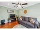 Gathering room with hardwood floors, gray couch and ceiling fan at 11424 Zenith Cir, Tampa, FL 33635