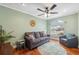 Gathering room with hardwood floors, gray couch and a window at 11424 Zenith Cir, Tampa, FL 33635