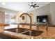 Modern kitchen sink with a sleek faucet and granite countertop at 11424 Zenith Cir, Tampa, FL 33635