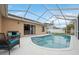 Inviting pool area with screened enclosure and patio furniture at 11424 Zenith Cir, Tampa, FL 33635