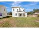 View of the home's backyard, showing a large grassy area at 11926 Riverhills Dr, Tampa, FL 33617