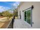 Modern balcony with glass sliding doors and metal railing, offering a neighborhood view at 11926 Riverhills Dr, Tampa, FL 33617