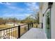 Private balcony with metal railing and view of yard at 11926 Riverhills Dr, Tampa, FL 33617