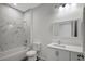 Modern bathroom with marble-look tile, a white vanity, and a bathtub at 11926 Riverhills Dr, Tampa, FL 33617