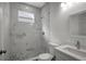 Bathroom with marble-look shower and a quartz vanity at 11926 Riverhills Dr, Tampa, FL 33617