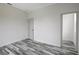 Empty bedroom with wood-look floors and an adjacent closet at 11926 Riverhills Dr, Tampa, FL 33617