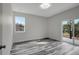 Bedroom with wood-look floors, a window, and sliding glass doors to balcony at 11926 Riverhills Dr, Tampa, FL 33617