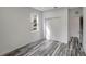 Spacious bedroom with wood-look floors, a double door closet, and a window at 11926 Riverhills Dr, Tampa, FL 33617