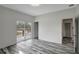 Bright bedroom with wood-look floors and sliding glass doors leading to a private balcony at 11926 Riverhills Dr, Tampa, FL 33617