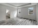 Spacious bedroom with wood-look floors and ensuite bathroom at 11926 Riverhills Dr, Tampa, FL 33617