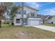 Two-story modern home with gray and white exterior at 11926 Riverhills Dr, Tampa, FL 33617