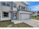 Two-story modern home with attached garage and balcony at 11926 Riverhills Dr, Tampa, FL 33617