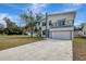 Two-story house with balcony, driveway, and landscaping at 11926 Riverhills Dr, Tampa, FL 33617