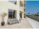 Relaxing patio with seating area, offering a view of palm trees and the city at 1200 Gulf Blvd # 102, Clearwater Beach, FL 33767