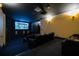 Luxurious home theater with large screen, projector, and comfortable reclining seats at 130 Riviera Dunes Way # 605, Palmetto, FL 34221