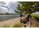 Serene waterfront walkway with benches, offering peaceful views at 130 Riviera Dunes Way # 605, Palmetto, FL 34221