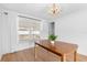 Dining room features wood table, chandelier, and pool view at 13561 105Th Ave, Largo, FL 33774