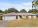 Single-story home with attached garage and landscaped yard at 13561 105Th Ave, Largo, FL 33774