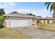 White garage door and driveway of a single-story house at 13561 105Th Ave, Largo, FL 33774