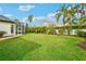 Large backyard with a screened enclosure and tropical landscaping at 15209 Leith Walk Ln, Tampa, FL 33618