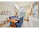 Elegant dining room featuring a rustic wood table and blue chairs at 15209 Leith Walk Ln, Tampa, FL 33618