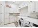 Laundry room with white cabinets and LG washer and dryer at 15209 Leith Walk Ln, Tampa, FL 33618