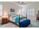 Spacious Primary bedroom with a post bed, blue accents and a plush velvet bench at 16213 Diamond Bay Dr, Wimauma, FL 33598