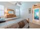 Charming bedroom with light blue walls, wooden dresser, and double doors at 16213 Diamond Bay Dr, Wimauma, FL 33598