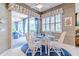 Charming breakfast nook with glass table and white wicker chairs at 16213 Diamond Bay Dr, Wimauma, FL 33598