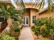 Entryway with lush landscaping and brick pathway to the front door at 16213 Diamond Bay Dr, Wimauma, FL 33598