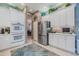 Modern kitchen with stainless steel refrigerator and white cabinetry at 16213 Diamond Bay Dr, Wimauma, FL 33598