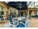 Enjoy dining alfresco on this covered patio with comfortable seating at 16213 Diamond Bay Dr, Wimauma, FL 33598