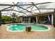 Inviting freeform pool with a screened enclosure at 16213 Diamond Bay Dr, Wimauma, FL 33598