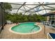 Inviting screened pool area with patio furniture, offering a relaxing outdoor space at 16213 Diamond Bay Dr, Wimauma, FL 33598