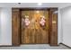 Double wood doors with pink flower accents at 1660 Gulf Blvd # 304, Clearwater Beach, FL 33767