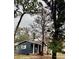 Exterior of a single-story home with dark blue siding and a well-manicured lawn at 1701 Shore Acres Ne Blvd, St Petersburg, FL 33703