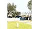 Exterior of a single-story home with dark blue siding, white trim, and a well-manicured lawn at 1701 Shore Acres Ne Blvd, St Petersburg, FL 33703