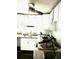 Bright kitchen featuring a modern ceiling fan, white cabinetry, and natural light from the window at 1701 Shore Acres Ne Blvd, St Petersburg, FL 33703