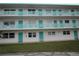 Three-story building with teal accents and balconies at 1900 59Th N Ave # 212, St Petersburg, FL 33714