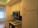 Kitchen boasts white cabinets, stainless steel appliances, and a gas stove at 1900 59Th N Ave # 212, St Petersburg, FL 33714