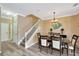 Bright dining room features hardwood floors and elegant chandelier at 2104 Park Crescent Drive, Land O Lakes, FL 34639