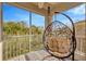 Relaxing screened balcony with hanging chair and nature views at 2104 Park Crescent Drive, Land O Lakes, FL 34639