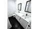 Modern bathroom with black hexagon tile floor and double vanity at 2318 Granada W Cir, St Petersburg, FL 33712