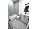 Modern bathroom with gray tile, white vanity, and hexagon floor tile at 2318 Granada W Cir, St Petersburg, FL 33712