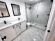 Updated bathroom with marble shower and double vanity at 2318 Granada W Cir, St Petersburg, FL 33712